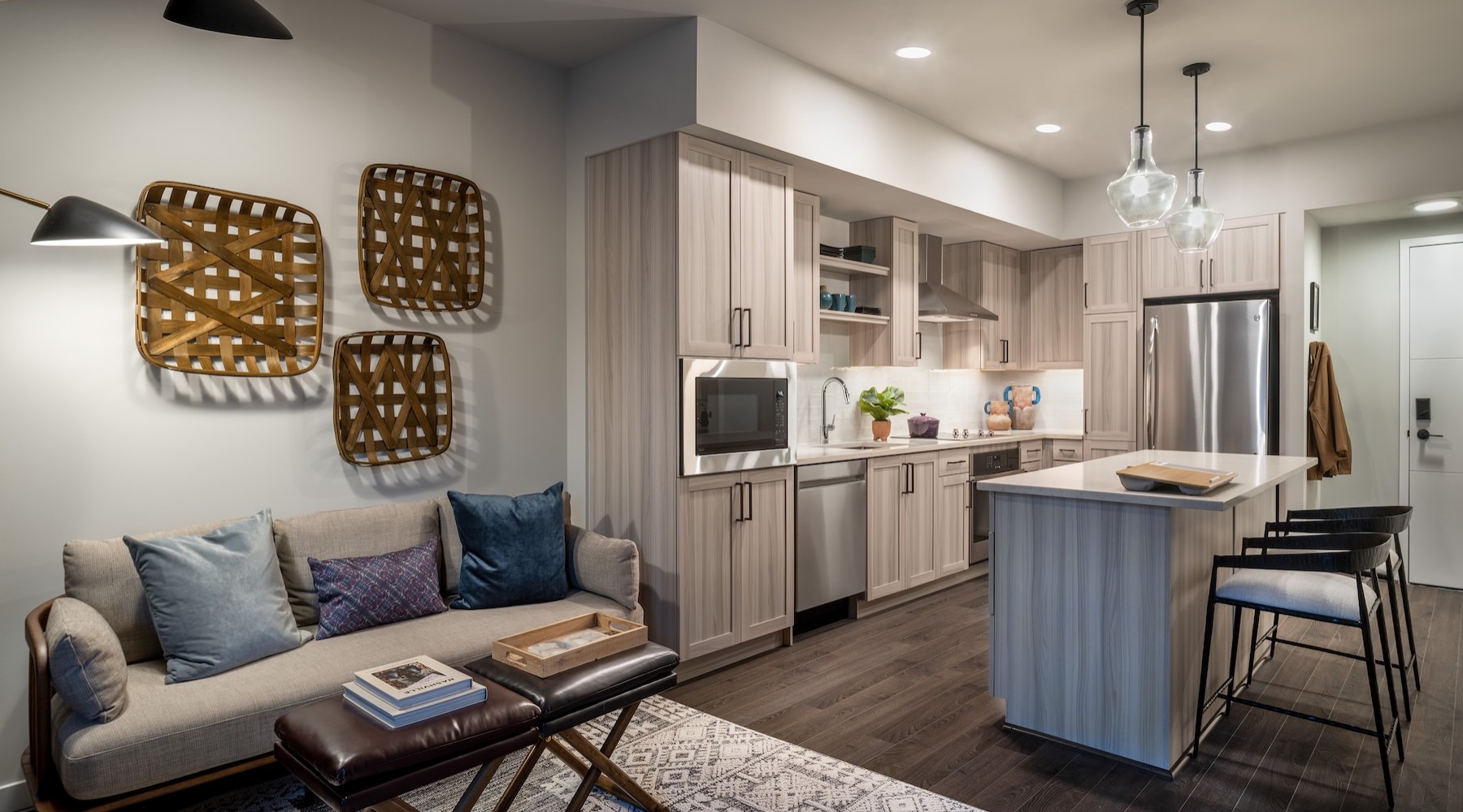 a living room with a couch and a kitchen