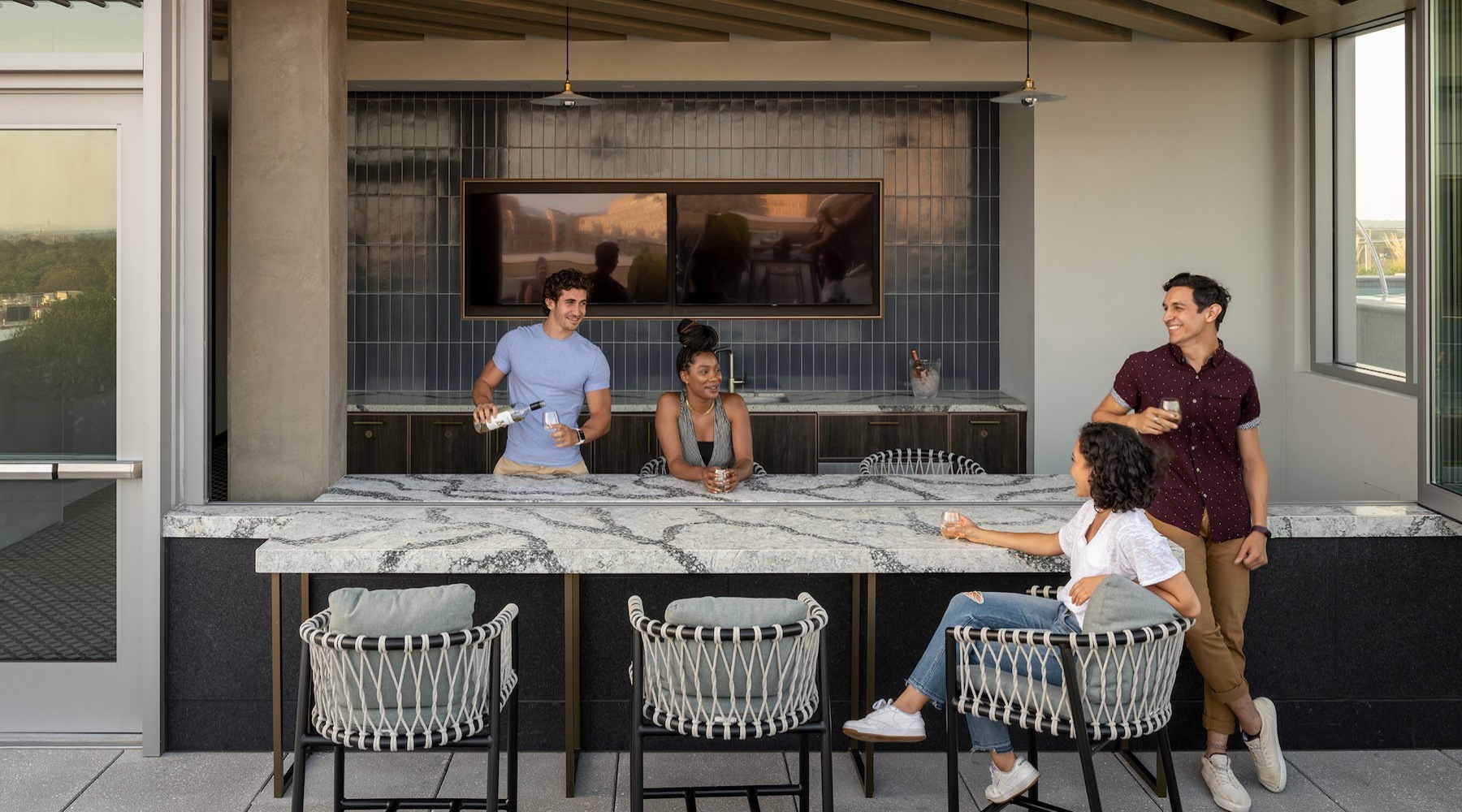 a group of people having drinks at a bar outside
