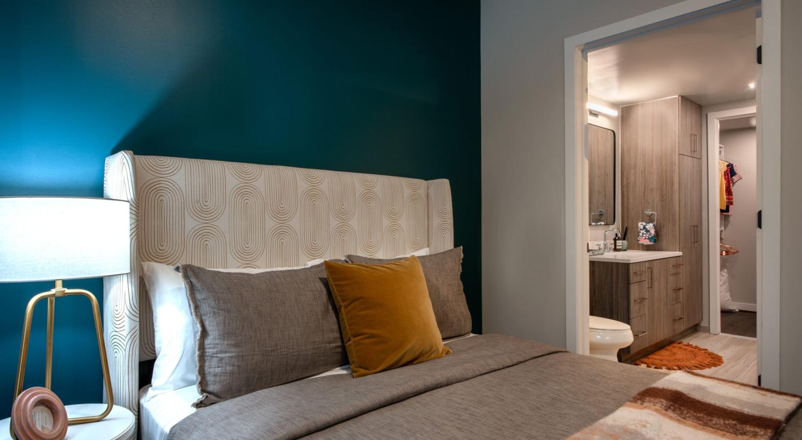 a bed with a yellow pillow